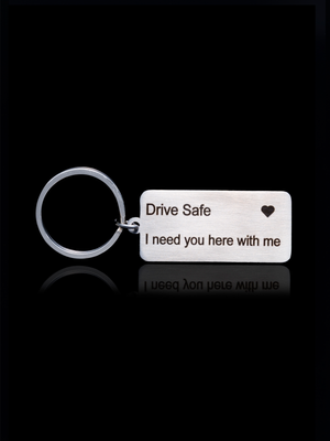 Keychain with 'Drive Safe I need you here with me' text on a stainless steel keychain